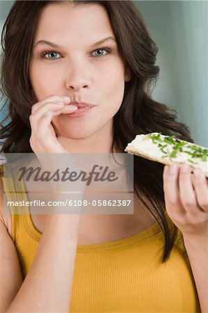 Portrait of a woman eating a bread