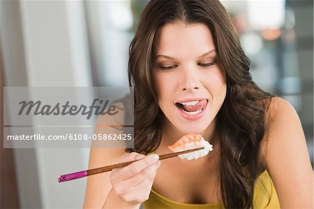 Close-up of a woman eating sushi