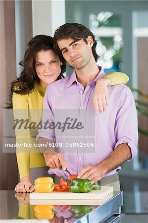 Man cutting bell pepper and smiling