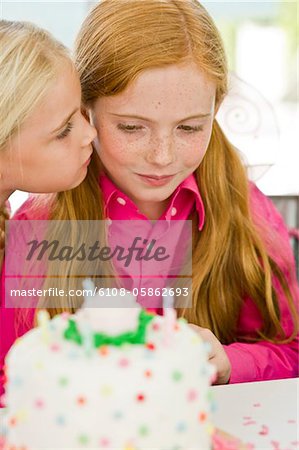 Close-up of a girl celebrating her birthday with her friend