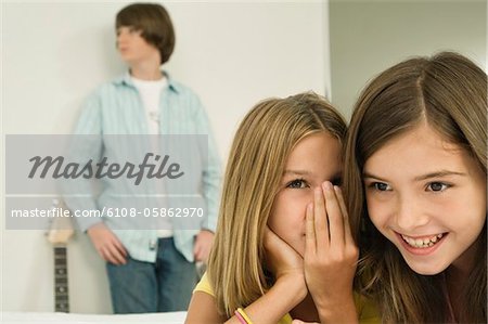 Girl whispering to her sister