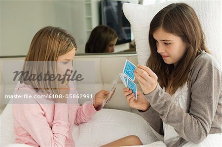Two girls playing cards