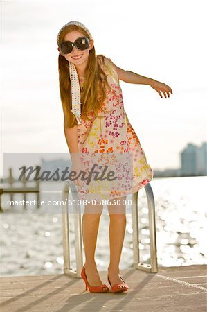 Girl standing on a jetty and smiling