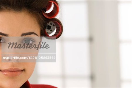 Portrait of a woman with hair curlers in her hair
