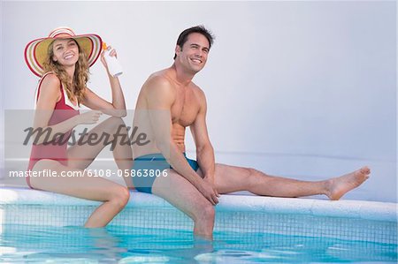 Couple sitting at the poolside