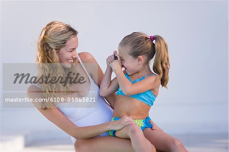 Girl taking a picture of her mother