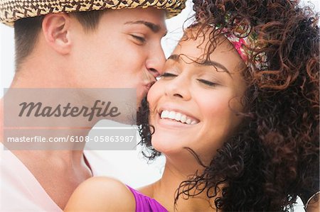 Man kissing a woman on cheek