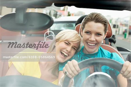 Two women sitting in a car after shopping