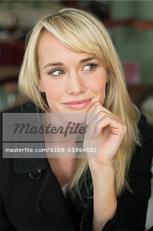 Woman sitting in a cafe and day dreaming