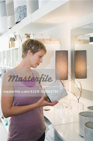 Woman holding a vase in a store