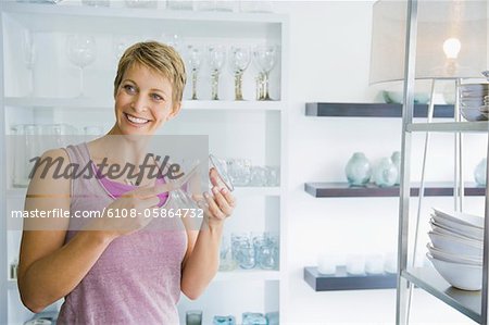 Woman holding a glass in a store