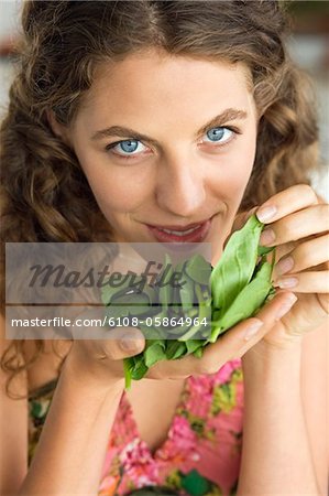 Frau riechen Spinat Blätter in der Küche