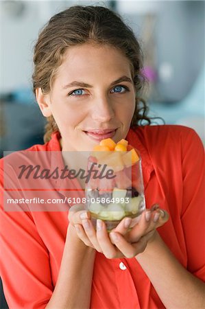 Portrait d'une femme tenant la salade de fruits