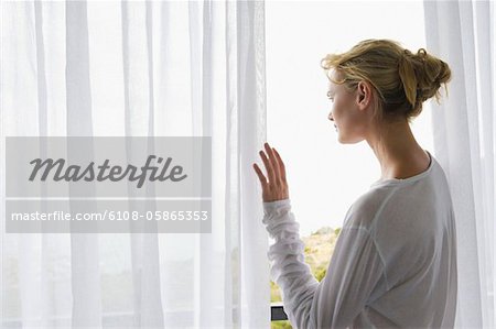 Rückansicht einer Frau auf dem Balkon stehend
