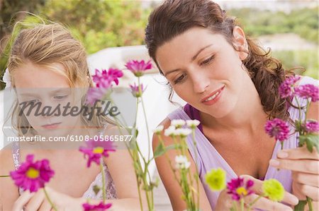 Frau mit ihrer Tochter anordnen von Blumen