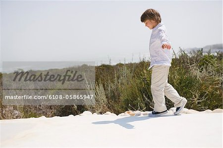 Boy walking at the poolside