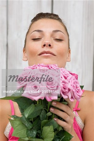 Woman smelling pink roses