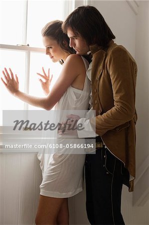 Man embracing a woman from behind