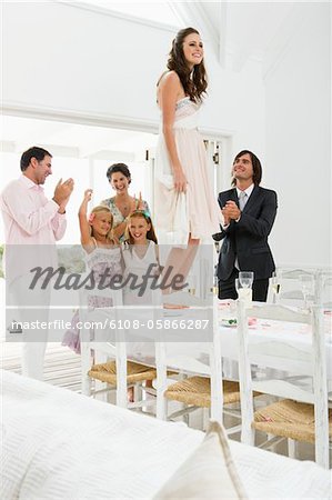 Newlywed couple with guests in a wedding party