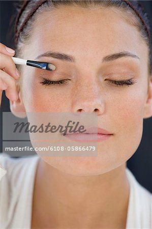 Close-up of a woman applying eye make-up