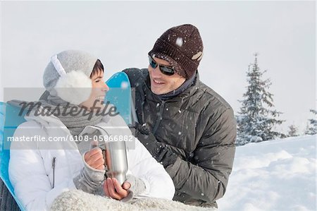 Young couple in ski wear resting
