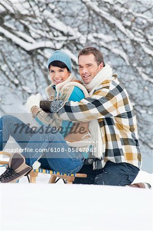 Young couple embracing on sled