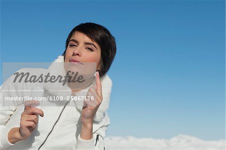 Young woman applying moisturizer