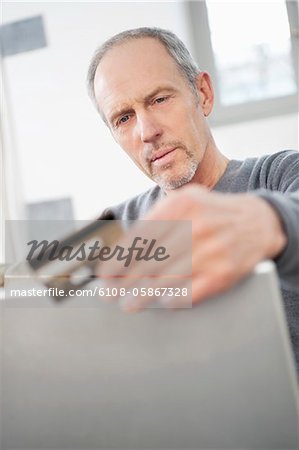 Man doing online shopping with a laptop