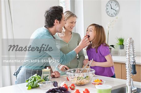 Family preparing food in the kitchen