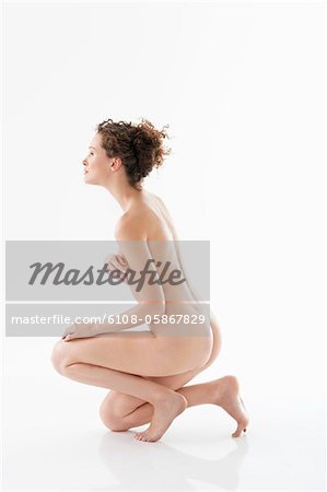 Naked woman covering her breasts