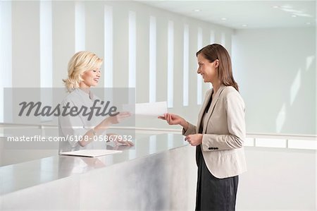 Female nurse giving medical report to a woman