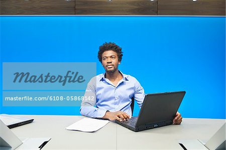 Businessman working on a laptop in a conference room