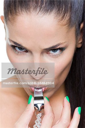 Young woman blowing whistle