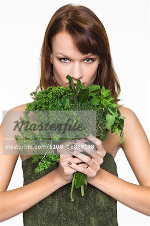Young woman holding fresh herbs