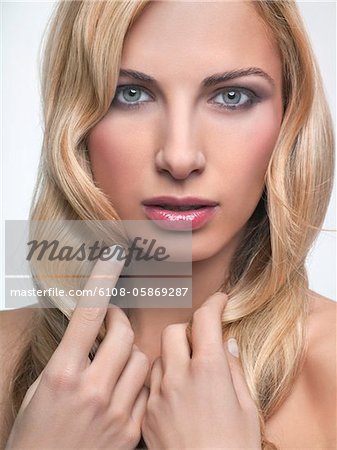 Young woman touching her hair