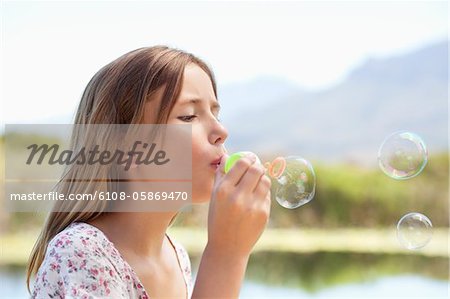 Close-up of a girl blowing bubbles