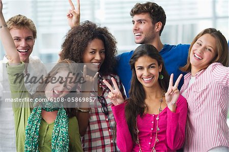 Multi-ethnic university students standing together and cheering