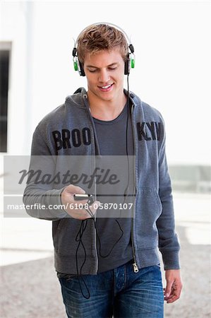 Man listening to music with headphones and smiling