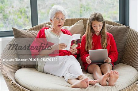 Senior woman and her granddaughter looking surprised