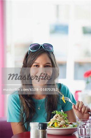 Portrait of a beautiful woman eating food in a restaurant