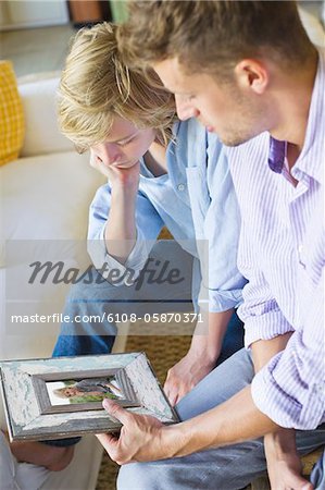 Man and a little boy looking at picture frame