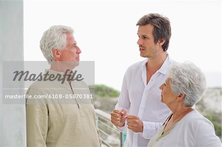 Mid adult man discussing to his parents