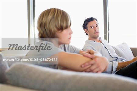 Man looking at his son looking angry