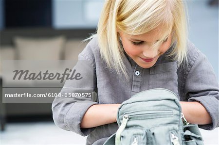 Girl searching in her bag