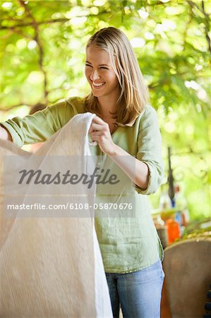 Smiling woman holding a tablecloth