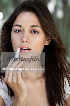 Portrait d'une jeune femme belle, appliquer le rouge à lèvres