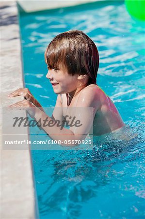 Boy smiling in a swimming pool