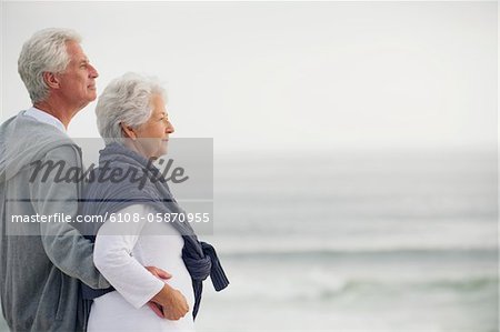 Side profile of a senior couple looking at the sea