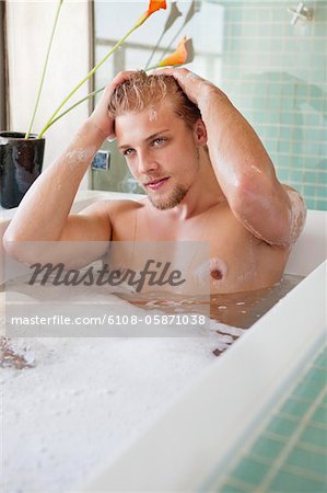 Man having bubble bath in a bathtub
