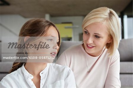 Woman looking at daughter and smiling